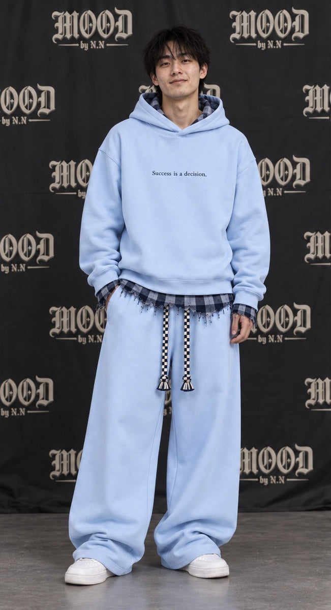 Monaco Set in blue on a model, front view: oversized hoodie with a frayed plaid layer and wide-leg trousers #color-blue