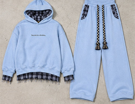 Monaco Set in blue: hoodie and wide-leg trousers on a stone background #color-blue