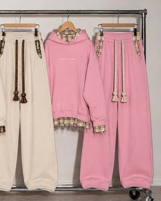 Monaco Set in pink: hoodie and wide-leg trousers hanging on a rack #color-pink